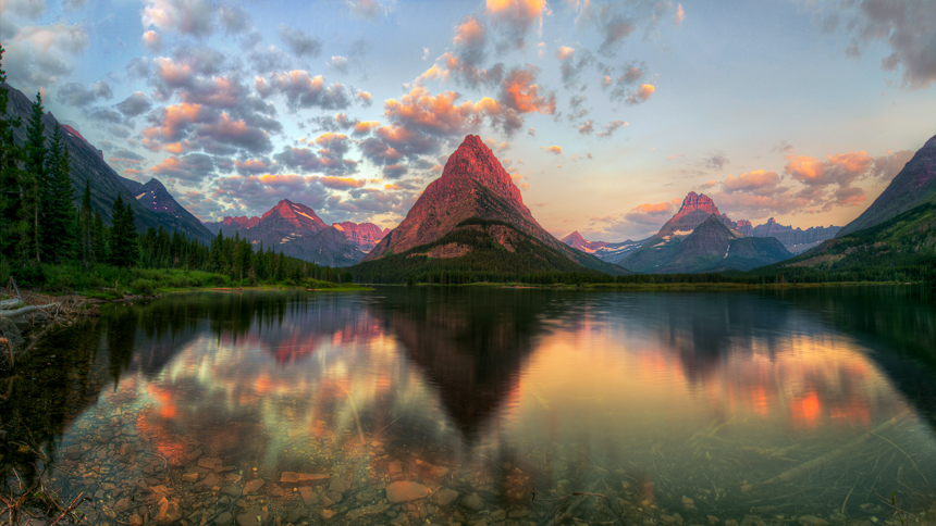 a photograph of swiftcurrent lake in glacier national park