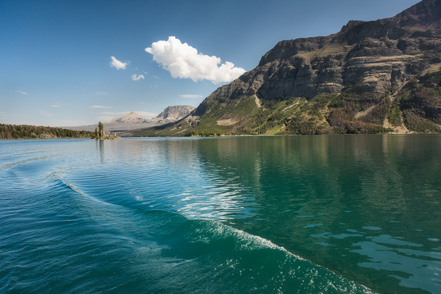 a photograph of the wake of a boat in st mary's lake in glacier national park montana
